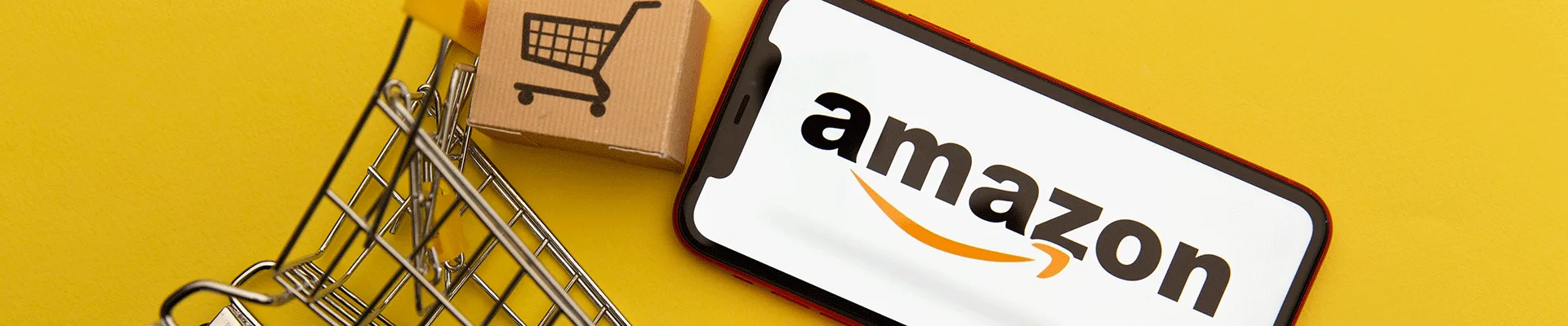 yellow background with amazon phone and mini shopping cart