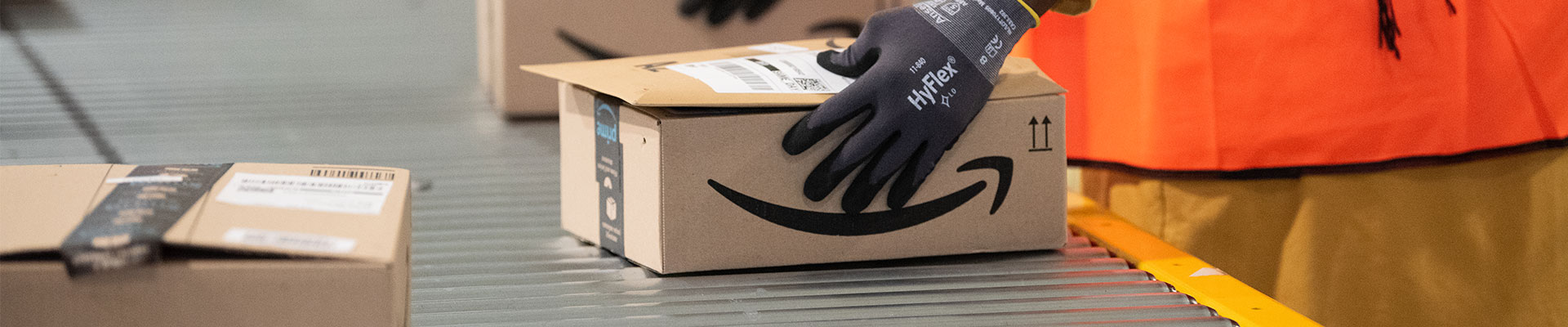 An Amazon warehouse employee oversees orders being fulfilled, a key strategy for company success on the marketplace.