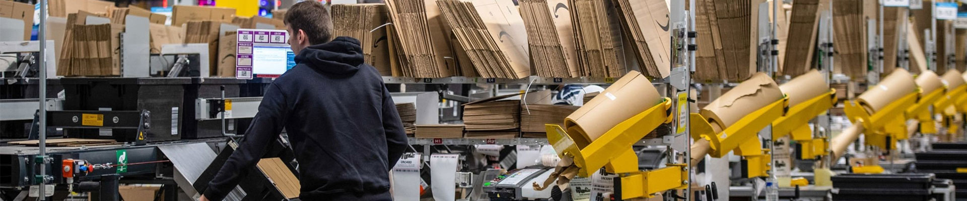 An amazon employee prepares to begin the process of packaging orders, which can be streamlined by finding the right Amazon FBA partner.